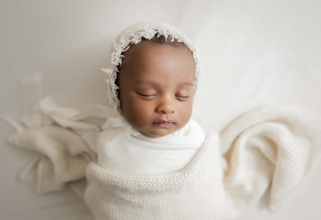 Newborn baby wrapped pose